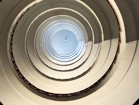 Abstract spiral staircase architecture with circular pattern and symmetrical design.