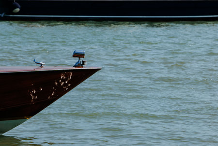Elegant wooden boat with shiny surface on calm water.の写真素材