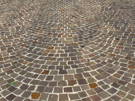 Intricate pattern of stone cobblestone pavement in urban setting.の写真素材