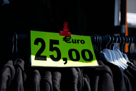 Clothing rack with euro price tag in bright sunlight.