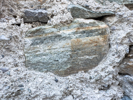 Close-up of sedimentary rock formation with layered textures and subtle earth tones.