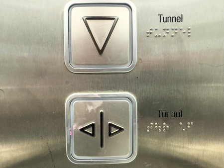 Elevator control panel with braille buttons and german labels.