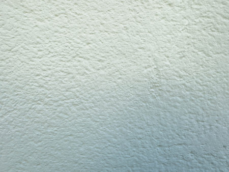 Textured light blue wall surface with subtle gradient.