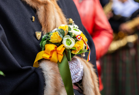 Elderly person holding colorful bouquet with yellow and green accents.の写真素材