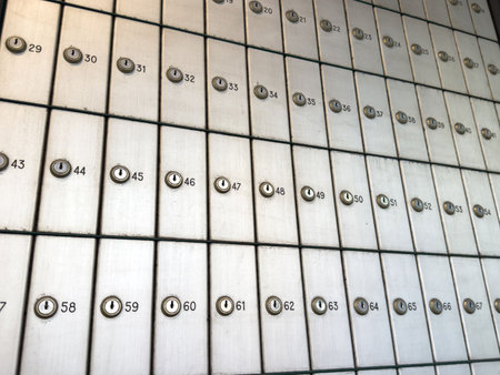 Rows of secure numbered mailboxes in post office setting for public use.の写真素材