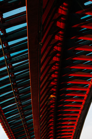 Abstract perspective of modern bridge structure with bold red and blue patterns.の写真素材