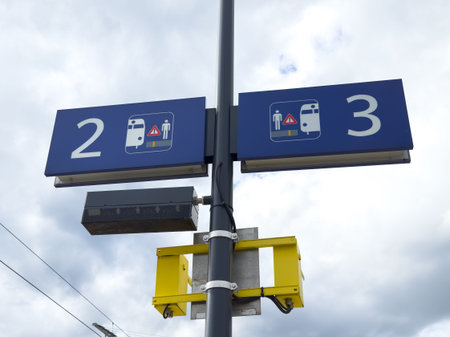 Train platform signage showing platforms 2 and 3 against cloudy sky.の写真素材