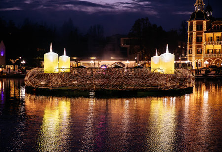 Velden, Austria - December 20, 2024: Schlosshotel am Woerthersee shines brightly at night with festive lights and candles, enhancing the winter ambiance during Advent seasonの写真素材