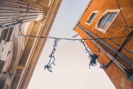 Dramatic architectural perspective with columns and orange facade.の写真素材