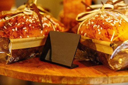 Freshly baked bread with sugar crystals on wooden display.