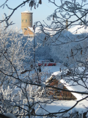 Winter landscape in the town. Street covered with snowの写真素材
