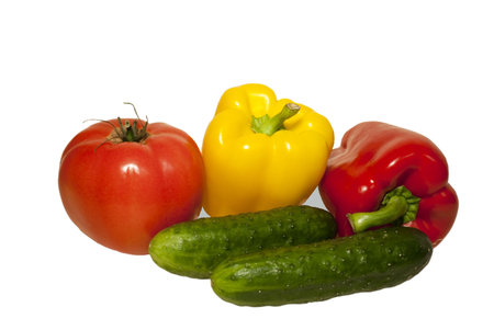 Vegetables on white background isolated. Two cucumber, two peppers - red and yellow, tomatoの写真素材