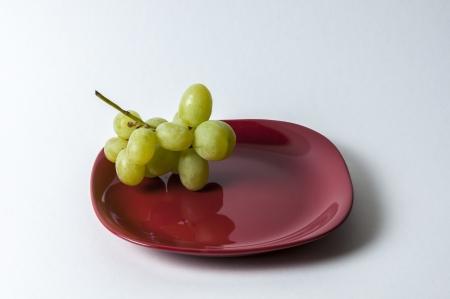 red plate with grape set-upの写真素材