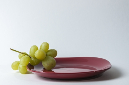 red plate with grape set-upの写真素材