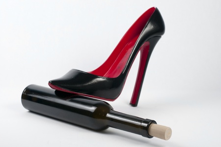 Red Shiny shoe stepping on bottleの写真素材