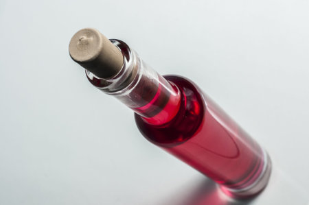 Ice wine bottle with red colored liquid inside