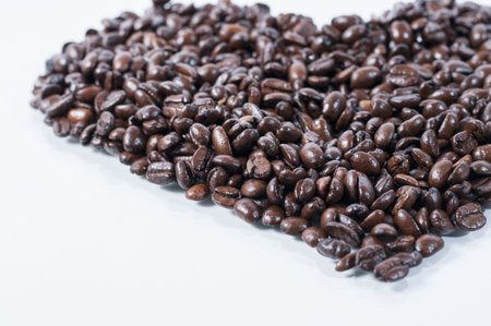 herat shape coffee beans on a white counter top