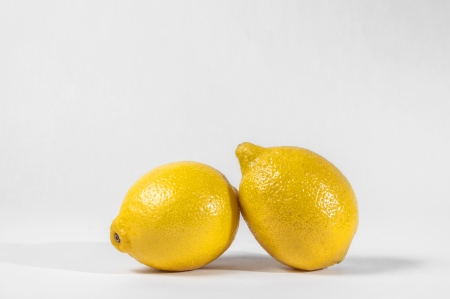 A pair of yellow lemon on white backgroundの写真素材