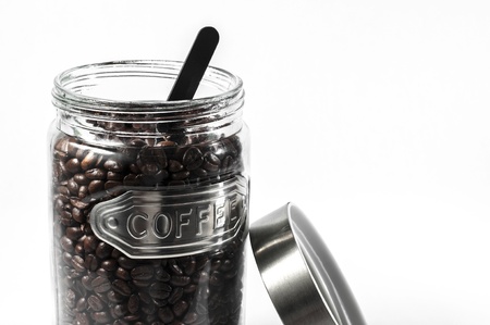 Coffee beans in an open glass jarの写真素材