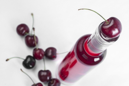 Red cherry and wine bottle close upの写真素材