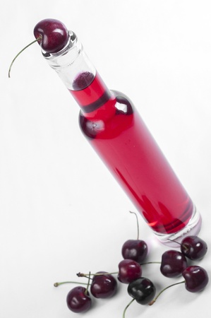 Red cherry and wine bottle close upの写真素材