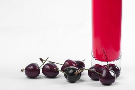 Red cherry and wine bottle close upの写真素材