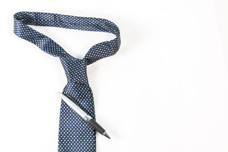 Pen on top of blue tie no white backgroundの写真素材