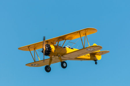 Yellow Bi plane with clear sky background