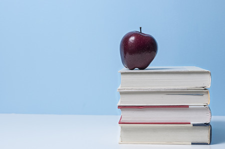 Apple and books with blue back groundの写真素材
