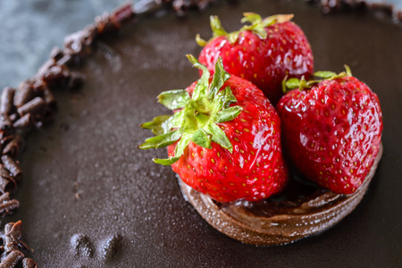 Strawberry close up on top of chocolate cakeの写真素材