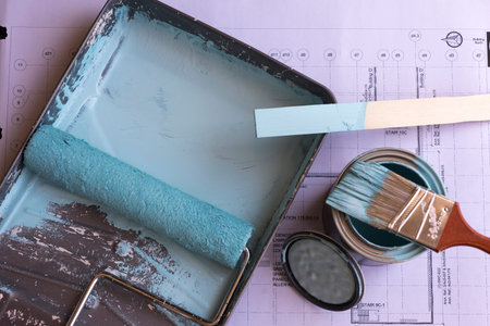 Roller brush , paint brush and accessories with paper below.の写真素材