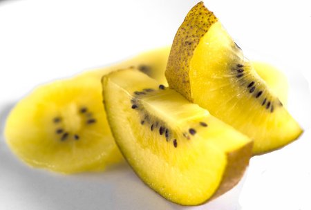 Slices of yellow kiwi on a white background.の写真素材