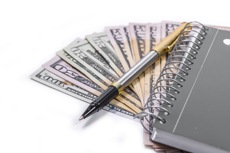 Noebook, pen, cash on white back groundの写真素材