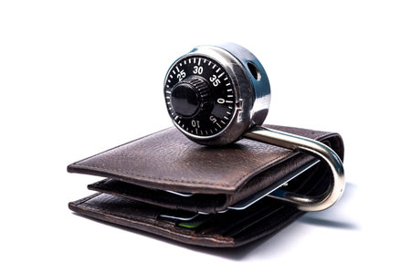 Combination lock on top of a leather walletの写真素材