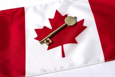 A key on top of a Canadian flagの写真素材
