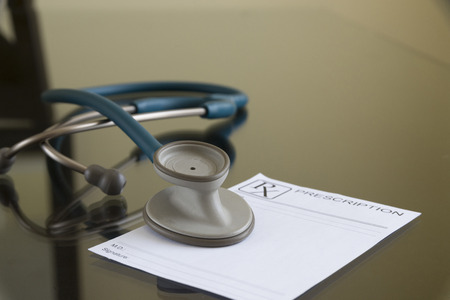 Prescription paper and stethoscope on gray back groundの写真素材