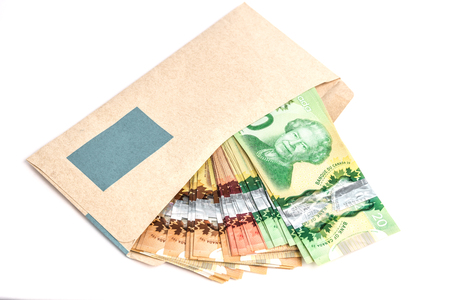 Canadian dollar bills inside a brown envelop.の写真素材