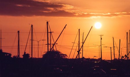 Setting sun at the harbour, orange sky.