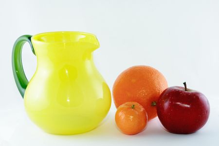 still life-fruit and yellow jug isolated on white backgroundの写真素材