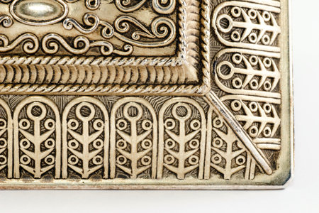 decorated ornament hand-made on white background, work in metalの写真素材