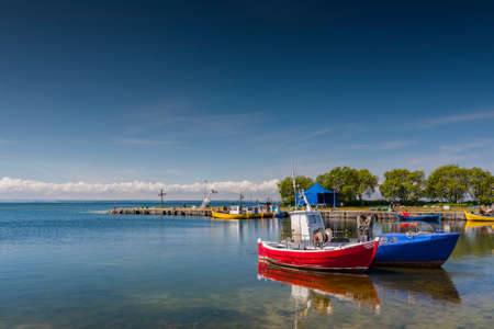 A quiet fishing port and moored small fishing boatsの写真素材