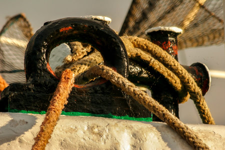 The mooring rope wrapped on the handles keeps the ship at the quay, detail