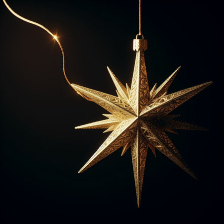 Golden Christmas star decoration on black background with copy space for text.の素材