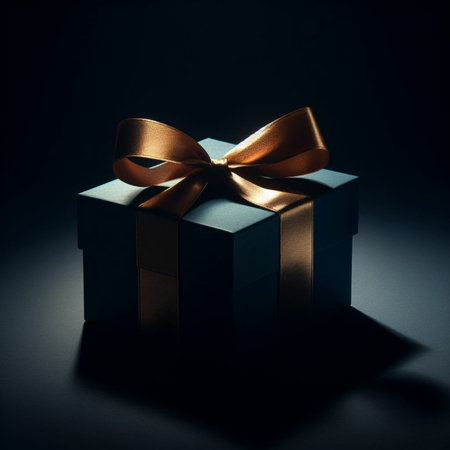 Gift box with golden ribbon on black background. Copy space.の素材