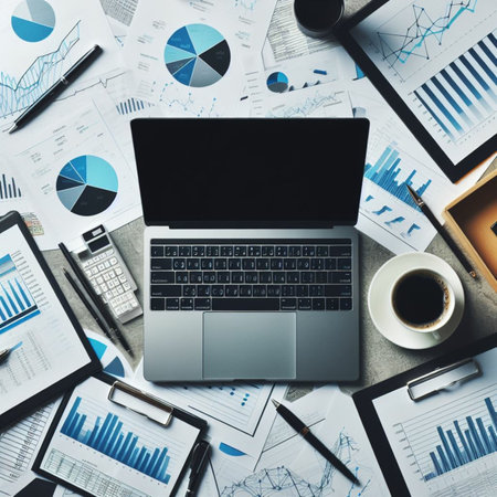 Top view of modern workplace with laptop, coffee cup and financial charts. Mockupの素材