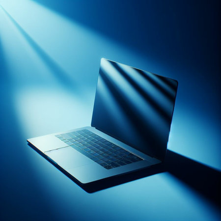 Laptop on a blue background with a beam of light and shadowの素材