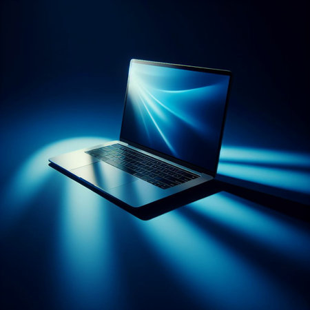 Laptop on a dark blue background with a bright beam of lightの素材