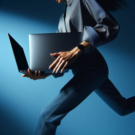 Young businesswoman with laptop on blue background. Close-up.の素材