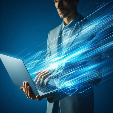 Close up of business person holding laptop against blue background with light raysの素材