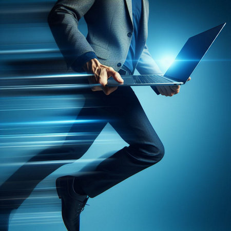 Close up of business person holding laptop against blue background with light raysの素材
